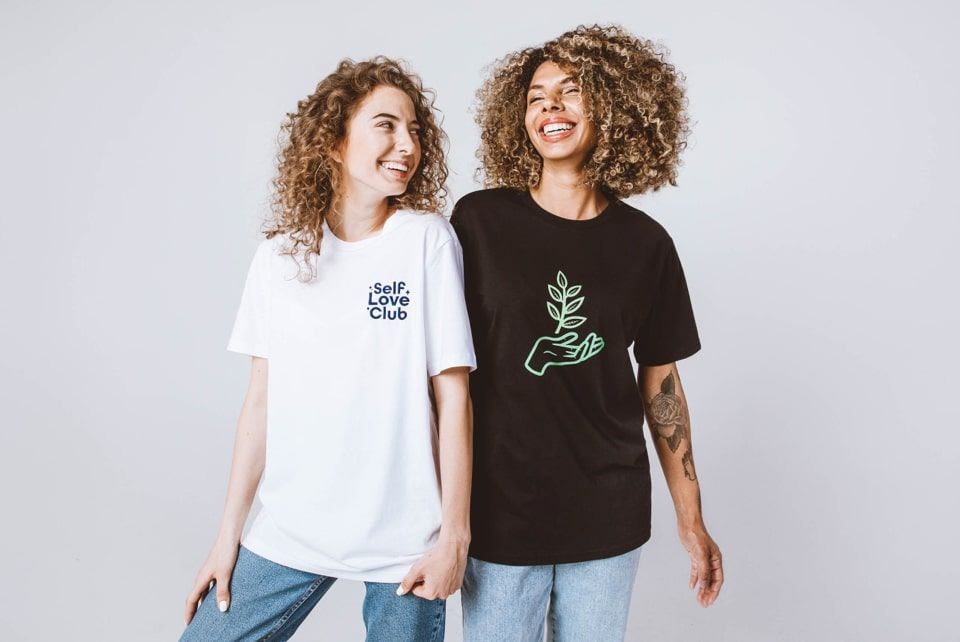two women in t-shirts with custom printed designs laughing