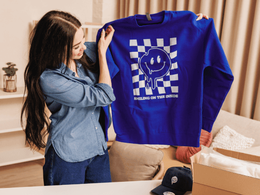 woman holding up a print on demand hoodie